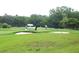 Scenic view of the golf course featuring golfers in the green landscape at 13524 Knotty Ln, Hudson, FL 34669