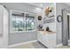 Charming dining nook with a view to the outdoors, featuring a cabinet and serving area at 13524 Knotty Ln, Hudson, FL 34669