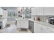 Stylish kitchen with white cabinets, stainless steel appliances, and a view of the backyard at 13524 Knotty Ln, Hudson, FL 34669