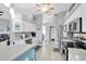 Well-lit kitchen features white cabinetry, stainless steel appliances, and a stylish breakfast bar with tiled backsplash at 13524 Knotty Ln, Hudson, FL 34669