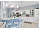 Bright kitchen features a breakfast bar with seating and stainless steel appliances, complemented by ample white cabinetry at 13524 Knotty Ln, Hudson, FL 34669