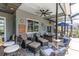 Covered lanai with comfortable seating, ceiling fan, and decorative accents at 13524 Knotty Ln, Hudson, FL 34669