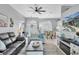 Open-concept living area with dining space and a view of the pool, perfect for entertaining at 13524 Knotty Ln, Hudson, FL 34669