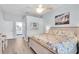 Bright main bedroom features a ceiling fan and an ensuite bathroom at 13524 Knotty Ln, Hudson, FL 34669