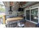 This outdoor kitchen features a grill, bar area, television, and decorative elements at 13524 Knotty Ln, Hudson, FL 34669