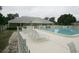 Community pool and recreation area with lounge chairs and well-maintained landscaping at 13524 Knotty Ln, Hudson, FL 34669