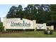 Meadow Oaks Golf & Country Club entrance sign with manicured landscaping at 13524 Knotty Ln, Hudson, FL 34669