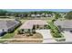 Aerial view of home featuring landscaping, a paved driveway, and a lake view at 1420 Winding Willow Dr, Trinity, FL 34655