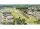 Aerial view of the golf course community showcasing the lush landscaping and winding water features at 1420 Winding Willow Dr, Trinity, FL 34655