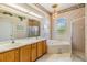 Bathroom featuring double sinks, soaking tub, and a separate shower at 1420 Winding Willow Dr, Trinity, FL 34655
