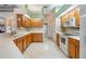 Bright kitchen featuring white countertops and appliances, and light wood cabinetry at 1420 Winding Willow Dr, Trinity, FL 34655