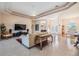 Bright and open living room with neutral tones, tile floors, and views of the front entrance and dining area at 1420 Winding Willow Dr, Trinity, FL 34655