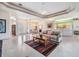 Bright open-concept living room with tile floors and an open view to the dining area and kitchen at 1420 Winding Willow Dr, Trinity, FL 34655