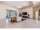 Spacious living room featuring a ceiling fan, tile flooring, and a sliding glass door offering backyard views at 1420 Winding Willow Dr, Trinity, FL 34655