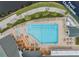 Detailed aerial view of the pool and clubhouse area, highlighting the pool layout, deck, and adjacent building at 1420 Winding Willow Dr, Trinity, FL 34655