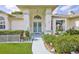 Inviting front entrance with decorative security door and lush garden area at 1496 Overland Dr, Spring Hill, FL 34608