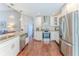 A kitchen with stainless steel appliances, granite countertops, and wooden floors at 1496 Overland Dr, Spring Hill, FL 34608