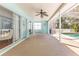 Large lanai with ceiling fan and access to the screened-in pool, perfect for outdoor entertaining and relaxation at 1496 Overland Dr, Spring Hill, FL 34608