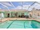 Enclosed pool featuring a large patio area, ideal for entertaining at 1496 Overland Dr, Spring Hill, FL 34608
