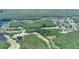 Panoramic aerial perspective of a golf course community, featuring verdant woods and tranquil lakes at 15906 Prince William Pl, Odessa, FL 33556