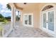 Beautiful balcony with columns features tile flooring, double doors, and outdoor access at 15906 Prince William Pl, Odessa, FL 33556