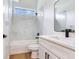 Bathroom with modern vanity, marble tiled shower with bright natural light at 15906 Prince William Pl, Odessa, FL 33556