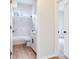 Bathroom with tub and marble tile surround, bright natural light at 15906 Prince William Pl, Odessa, FL 33556