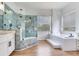 Bathroom with a glass shower and a bathtub at 15906 Prince William Pl, Odessa, FL 33556