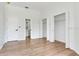 Open bedroom featuring a bathroom entry door and double closets at 15906 Prince William Pl, Odessa, FL 33556