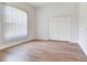 Bright bedroom with double closet doors and wood flooring at 15906 Prince William Pl, Odessa, FL 33556