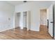 Bedroom featuring light wood floors, closets, and an open doorway at 15906 Prince William Pl, Odessa, FL 33556