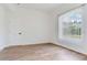 Bright bedroom with a large window, wood flooring and bright natural light at 15906 Prince William Pl, Odessa, FL 33556
