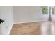 Bright room featuring wood flooring, a window, and modern fixtures at 15906 Prince William Pl, Odessa, FL 33556