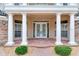 Welcoming entryway featuring white columns, brick pavers, and a double door entry at 15906 Prince William Pl, Odessa, FL 33556