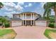 Beautiful two-story home featuring white columns, a three-car garage, and well-manicured landscaping at 15906 Prince William Pl, Odessa, FL 33556