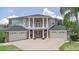 Majestic home with a grand facade, a circular driveway, and lush, green landscaping at 15906 Prince William Pl, Odessa, FL 33556