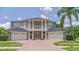 Stunning home with a grand facade, a circular driveway, and a meticulously landscaped yard at 15906 Prince William Pl, Odessa, FL 33556