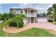 Two-story suburban home featuring a three-car garage, mature landscaping, and well-maintained lawn at 15906 Prince William Pl, Odessa, FL 33556