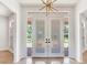 Elegant double front door with decorative glass and transom window, offering privacy and natural light at 15906 Prince William Pl, Odessa, FL 33556