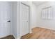 Bright hallway featuring a closet door and a window allowing natural light at 15906 Prince William Pl, Odessa, FL 33556