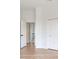 Bright hallway with light wood flooring and an open doorway to the upper level at 15906 Prince William Pl, Odessa, FL 33556
