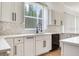 Kitchen featuring white cabinets, marble countertops, and stainless steel appliances at 15906 Prince William Pl, Odessa, FL 33556