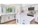 Bright kitchen featuring white cabinets, quartz countertops, and stainless steel appliances at 15906 Prince William Pl, Odessa, FL 33556