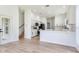 Open kitchen featuring white cabinets, stainless appliances, and an island with bar seating at 15906 Prince William Pl, Odessa, FL 33556