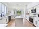 Modern kitchen with white cabinets, stainless steel appliances, and center island at 15906 Prince William Pl, Odessa, FL 33556