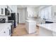 Modern kitchen with white cabinets, center island, and stainless steel appliances at 15906 Prince William Pl, Odessa, FL 33556