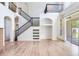 Spacious living area with a staircase, built-in shelving, and sliding glass doors for indoor-outdoor living at 15906 Prince William Pl, Odessa, FL 33556