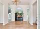 Open-concept living room with a modern fireplace, hardwood floors, and designer lighting at 15906 Prince William Pl, Odessa, FL 33556