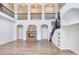 Expansive living room with tall ceilings, arched entryways, and a modern fireplace for cozy gatherings at 15906 Prince William Pl, Odessa, FL 33556