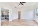 Bright living room with wood floors and a ceiling fan at 15906 Prince William Pl, Odessa, FL 33556